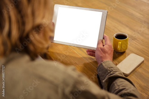 Woman holding digital tablet in cafe