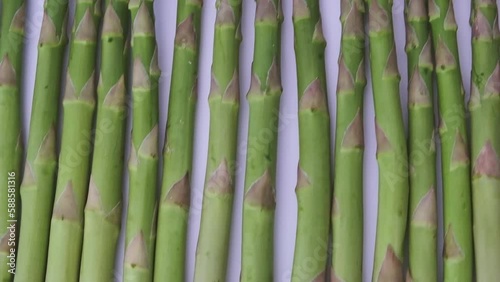 Rotating green fresh asparagus. top down view. photo