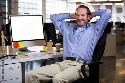 Smiling man sitting on chair at office