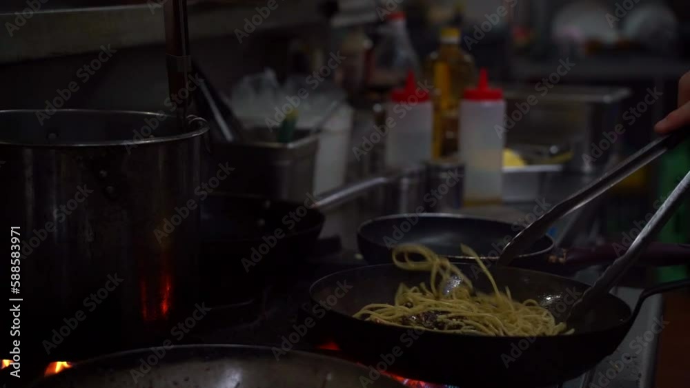 Snacks Cooking Slow motion close up shot capturing skilful chef cooking noodles ...