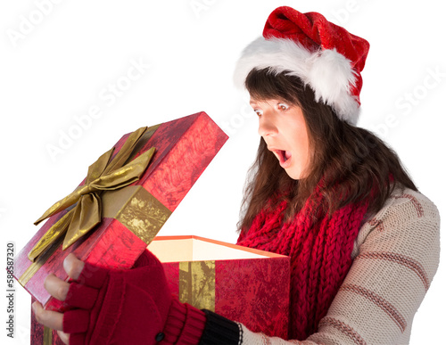 Shocked festive brunette opening a gift
