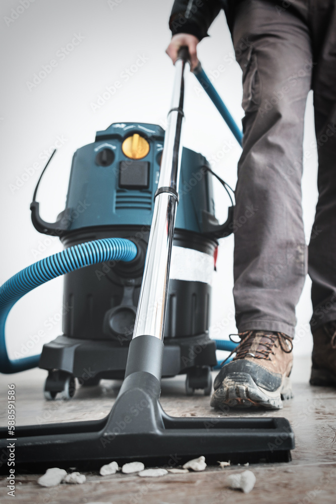 Close up on construction vacuum cleaner, construction cleaning service  after renovation, vertical Stock Photo | Adobe Stock