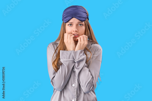 Young woman in pajamas biti...