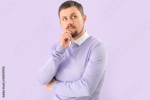 Handsome man biting nails o...