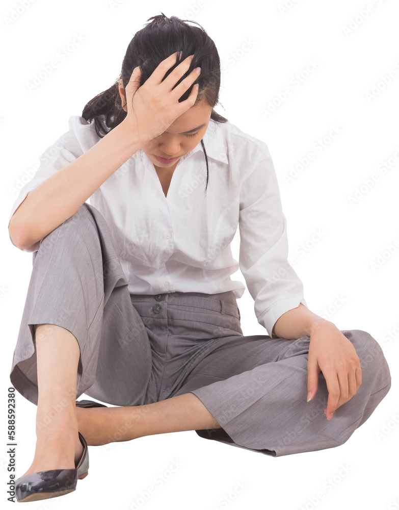 Depressed businesswoman sitting with hand on head Depressed businesswoman sitting with hand on head