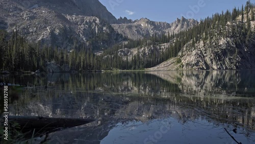 Landscape view of alpine lake with towering mountain peaks in background photo