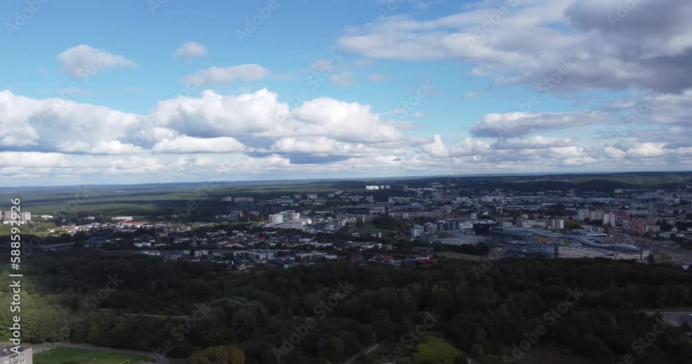 Aerial view of downtown Vilnius, Lithuania. You can see buildings in urban areas with large expanses of green areas adjacent to them, with lots of trees, with a bright sky, with lots of clouds. Aerial view of downtown Vilnius, Lithuania. You can see buildings in urban areas with large expanses of green areas adjacent to them, with lots of trees, with a bright sky, with lots of clouds.
