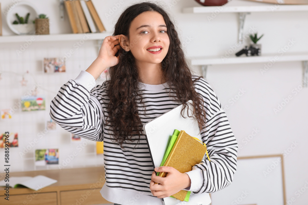 Female student with notebooks and laptop at home Female student with notebooks and laptop at home