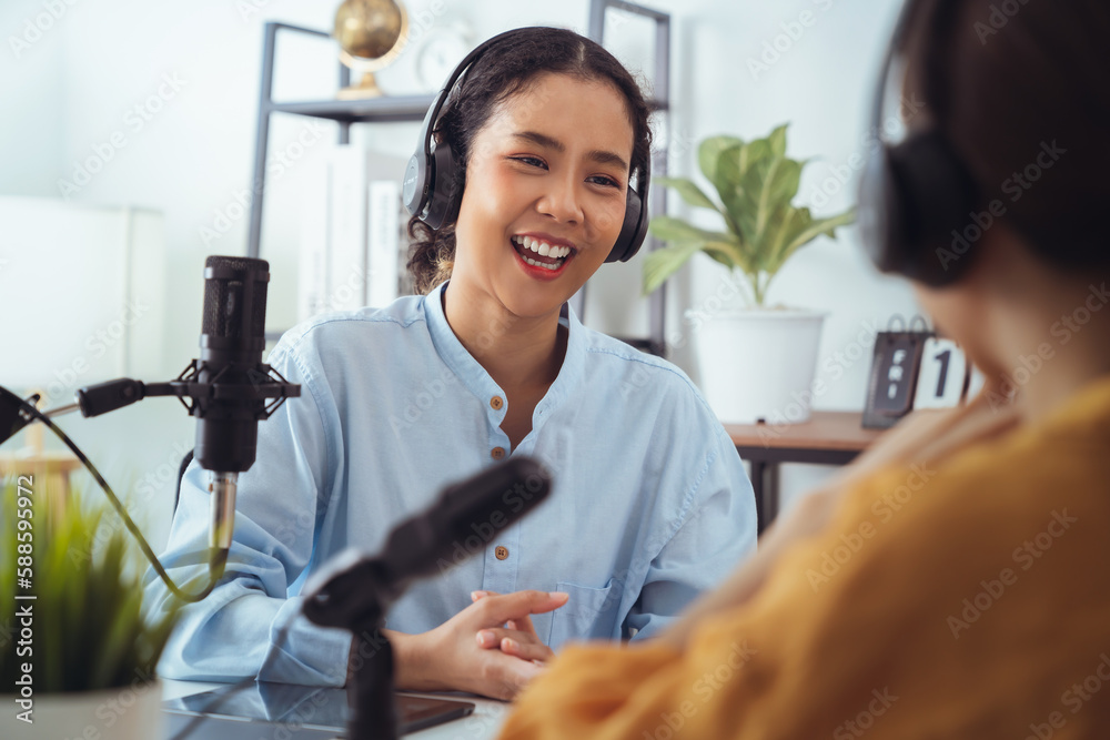 Φωτογραφία Young Asian woman use microphones wear headphones with laptop record podcast interview for radio