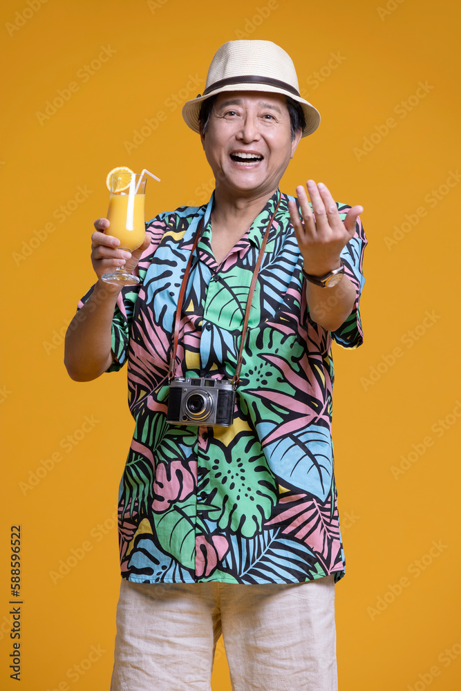 Cheerful senior Chinese man drinking juice Cheerful senior Chinese man drinking juice