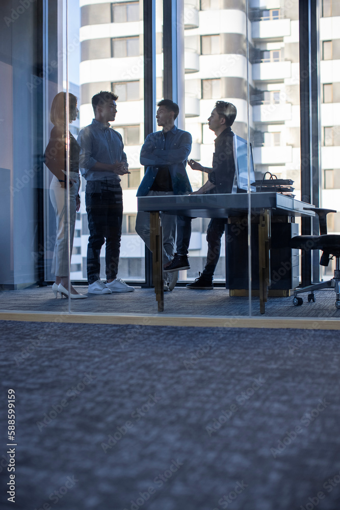 © Blue Jean Images - Confident Chinese designers having a meeting
