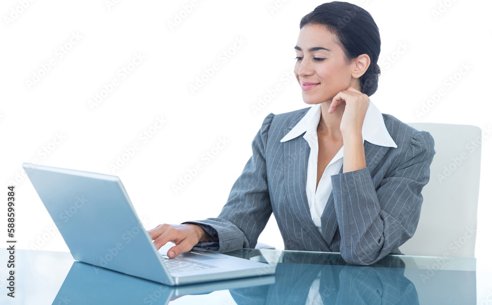 Smiling businesswoman using laptop at desk Smiling businesswoman using laptop at desk