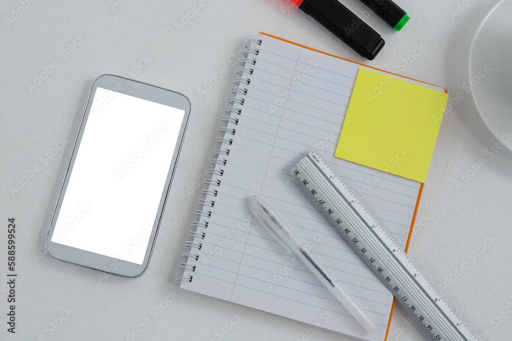 Mobile phone and stationery on white background Mobile phone and stationery on white background