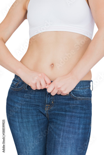 Midsection of slim woman buttoning jeans © vectorfusionart