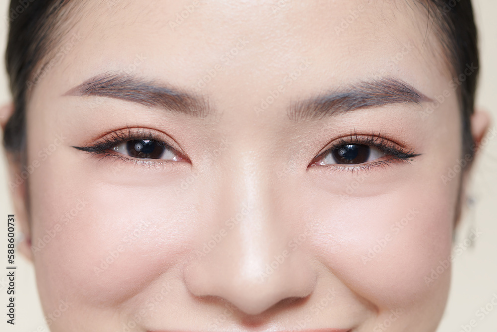 Happy young woman face with clear skin on brown background, closeup portrait