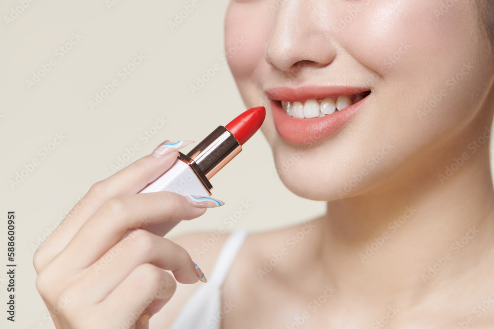 Portrait of gorgeous smiling woman holding red lipstick in hand Portrait of gorgeous smiling woman holding red lipstick in hand