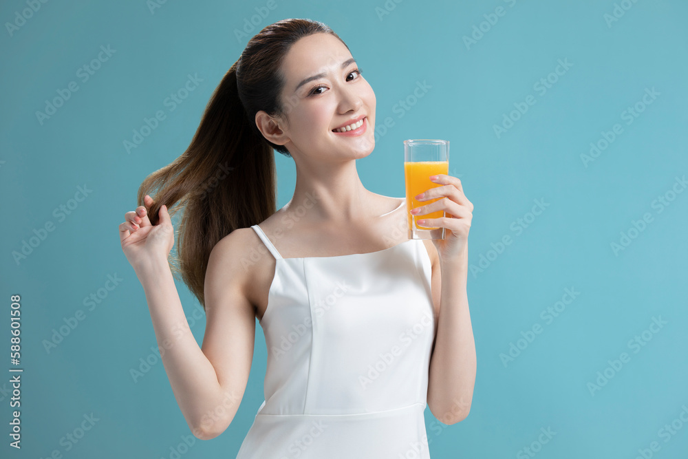 Beautiful young Chinese woman drinking orange juice Beautiful young Chinese woman drinking orange juice