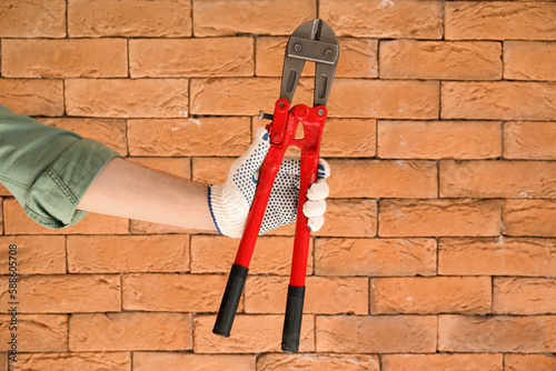 Worker with bolt cutter on ...