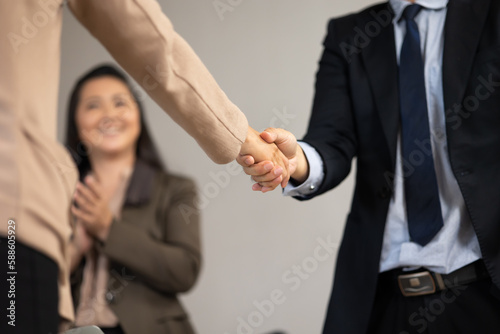 Fototapeta Naklejka Na Ścianę i Meble -  Asian business man shaking hands on a business cooperation agreement. Successful businessmen handshaking after good deal