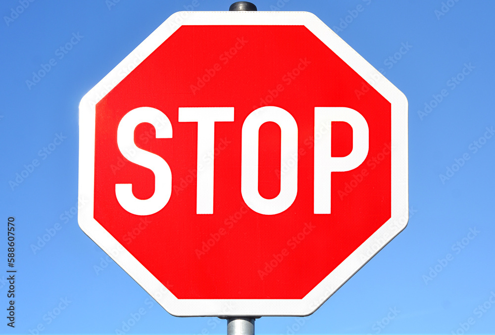 STOP sign against blue sky, closeup