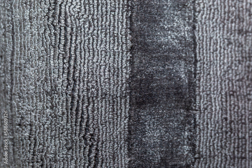 The pile surface of a dark gray carpet. Close-up. Interior decoration. Space for text.