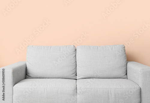 Grey couch near beige wall