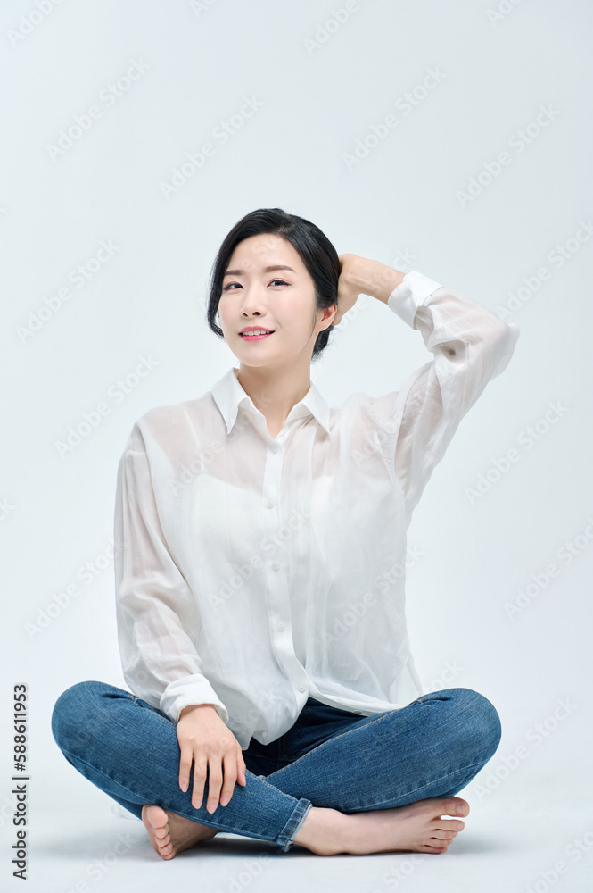 beautiful woman in blue jeans with a white background