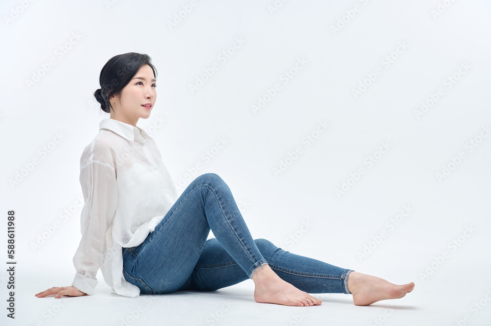 beautiful woman in blue jeans with a white background