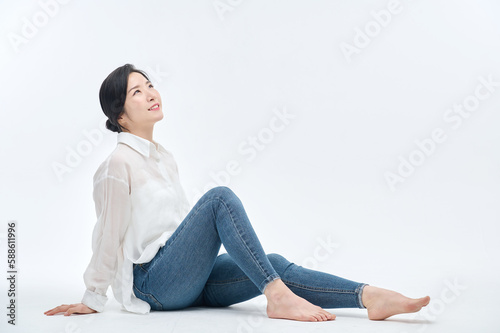 beautiful woman in blue jeans with a white background © PHOTOGRAPHER JH