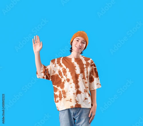 Teenage boy waving hand on ...