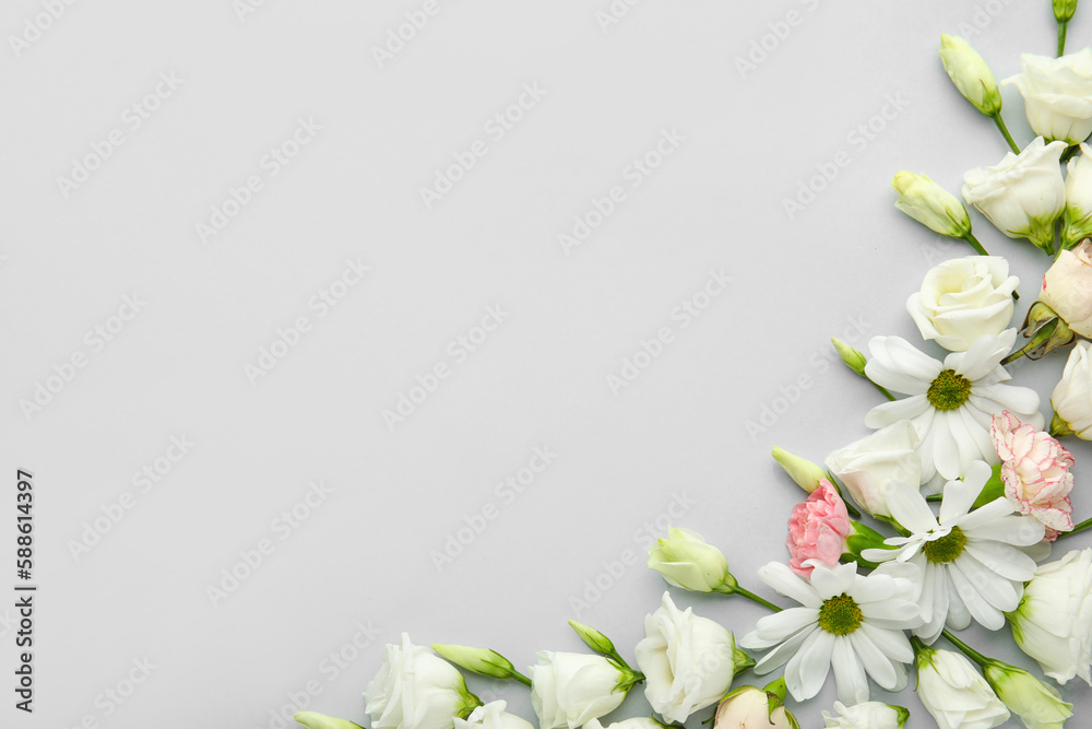 Beautiful composition with delicate flowers on light background
