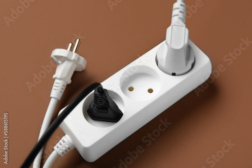 Wallpaper Mural Electric extension cord with plugs on brown background Torontodigital.ca