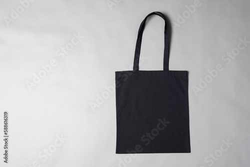 High angle view of black canvas bag with copy space on grey background