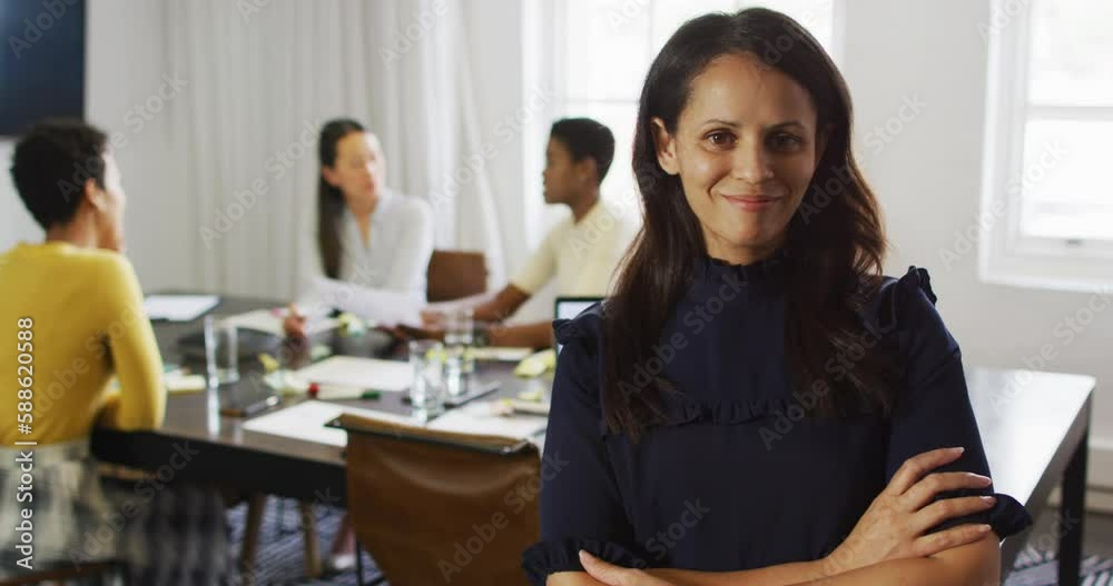 Happy caucasian businesswoman standing in office and looking at camera