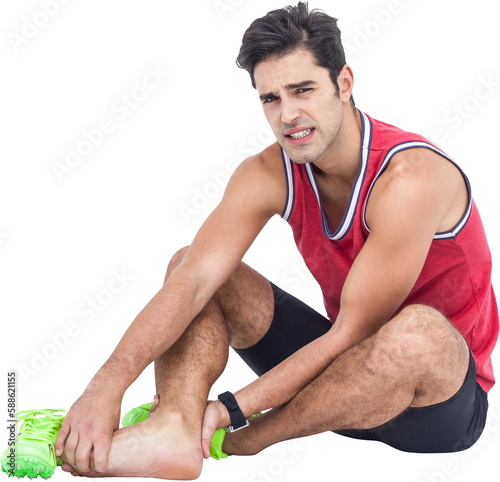 Portrait of male athlete with foot pain on white background