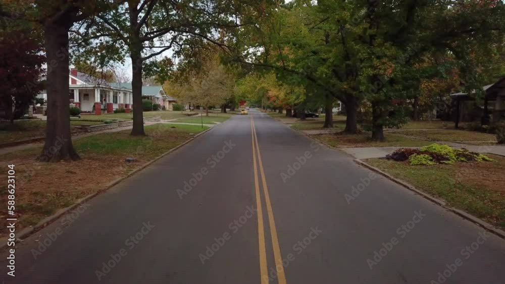 Backward dolly shot of a taxi driving through a rural neighbourhood in Georgia Backward dolly shot of a taxi driving through a rural neighbourhood in Georgia