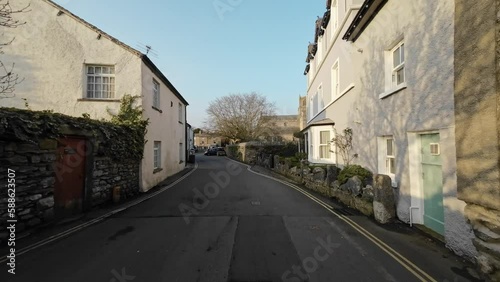 Editorial footage of the Cumbrian Village of Cartmel in the English Lake District. Showing traffic and tourists walking and shopping photo