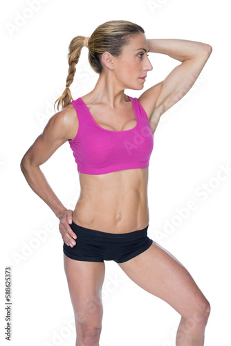 Female bodybuilder posing in pink sports bra © vectorfusionart