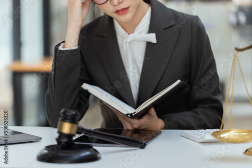 Asian lawyer woman working at law office desk, law firms, advice and justice concept.