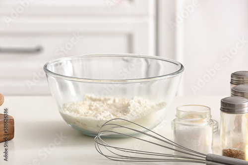 Bowl with flour for preparing Italian Grissini on table in kitchen