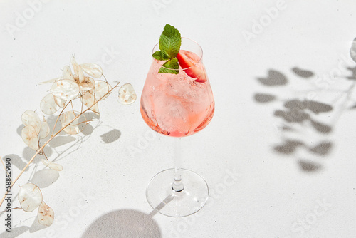 Tableau sur toile Strawberry alcoholic cocktail on white background with shadows