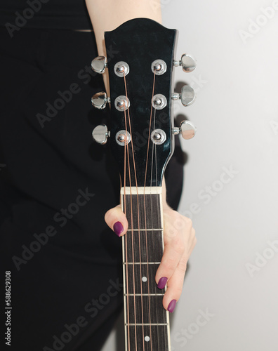 Guitar in the girl's hand.