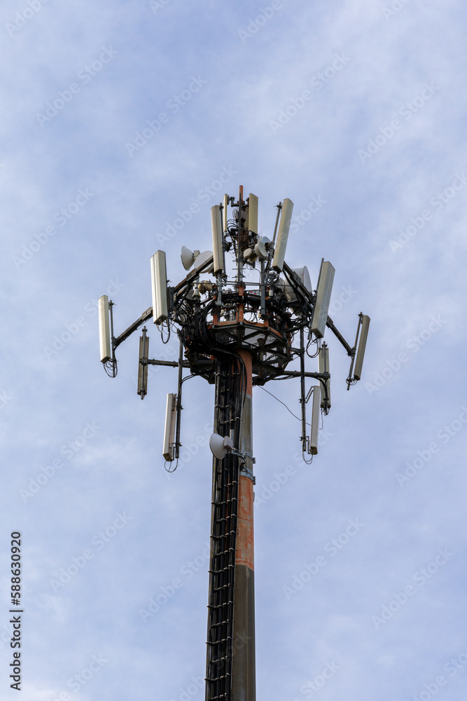 close-up view of a cellphone and internet 5G antenna with overcast sky copy space close-up view of a cellphone and internet 5G antenna with overcast sky copy space