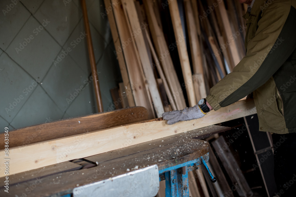 Carpenter planning the board (woodworking) Carpenter planning the board (woodworking)