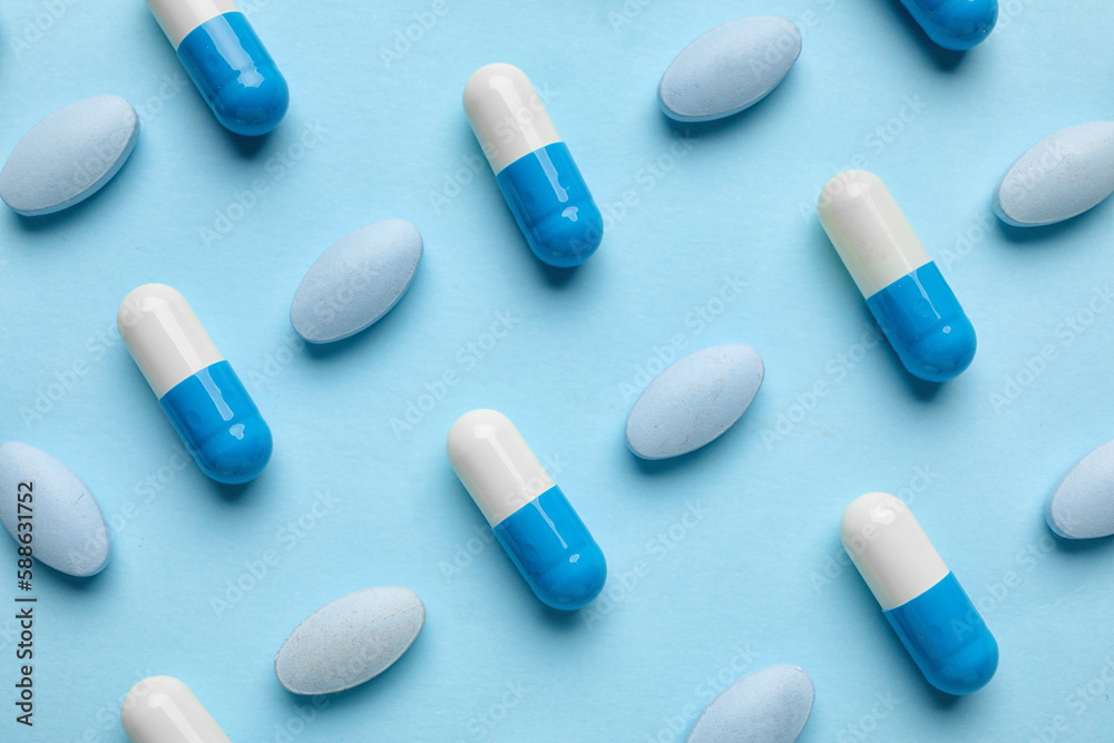 Different pills on blue background