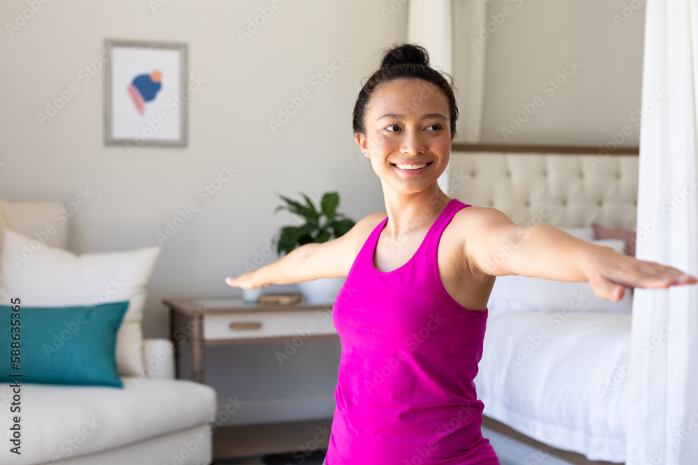 Happy asian woman doing yoga, stretching in bedroom Happy asian woman doing yoga, stretching in bedroom