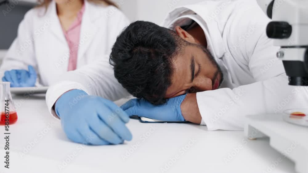 Scientist, sleep and man in laboratory, research and tired with burnout, overworked and workaholic. Researcher, male employee and medical professional asleep, fatigue and exhausted on break and rest