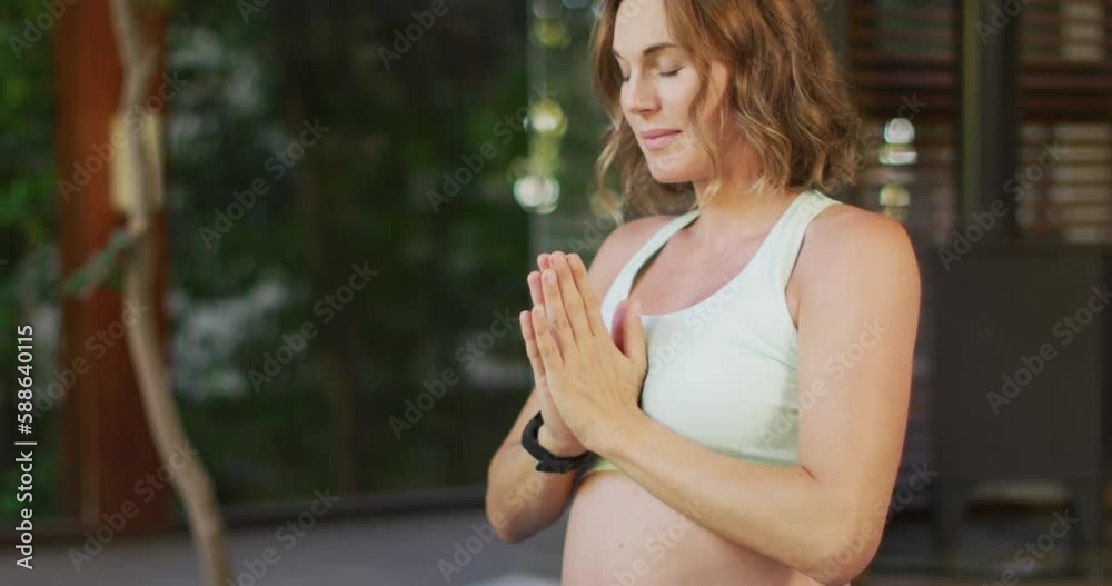 Relaxed caucasian pregnant woman practicing yoga in terrace Relaxed caucasian pregnant woman practicing yoga in terrace