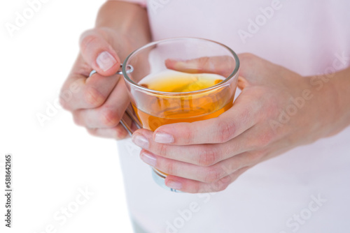 Midsection of woman holding glass of tea