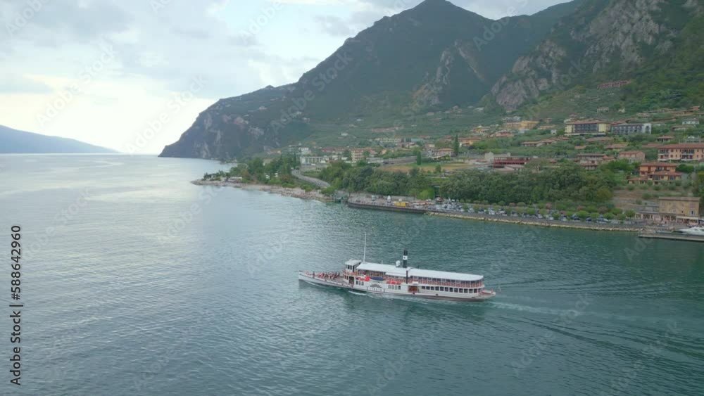DRONE, Tourist Ferry Sailing from Limone City, Garda Lake, Italy Aerial POI DRONE, Tourist Ferry Sailing from Limone City, Garda Lake, Italy Aerial POI